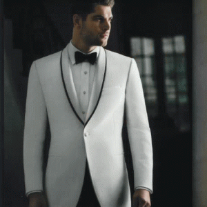 Man wearing white tuxedo with black trim label and black bow tie